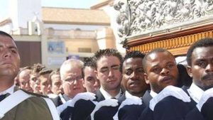 Costaleros subsaharianos ayudando a llevar un paso de Semana Santa en Melilla. Autor Manuel Soria